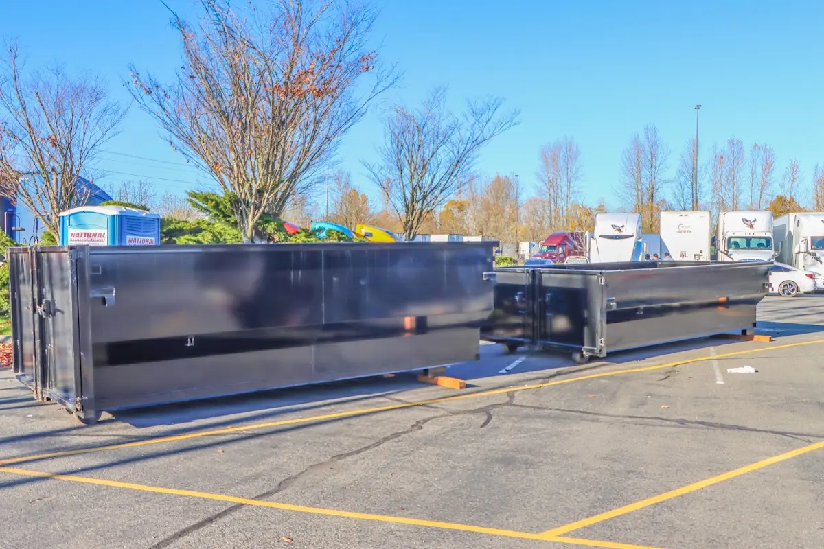 Professional dumpster rental service with roll-off container on residential driveway in Haverstraw